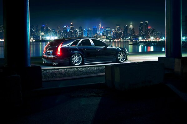 Black Cadillac on the background of the night city