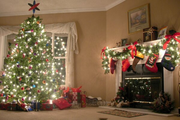 Christmas night next to the Christmas tree and fireplace