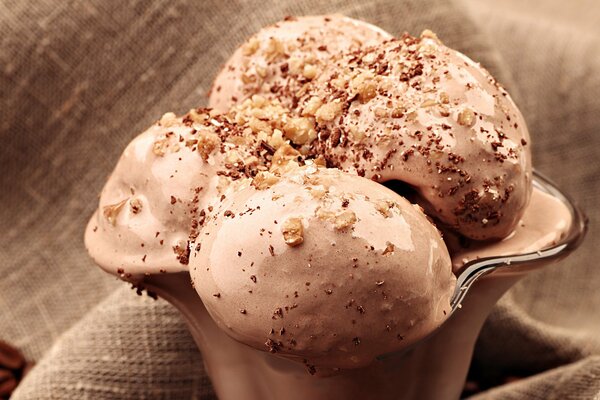 Chocolate ice cream balls sprinkled with nuts