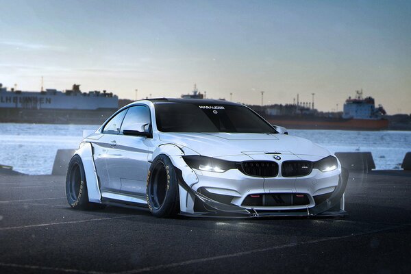 Car. Silver BMW M 4 on the embankment