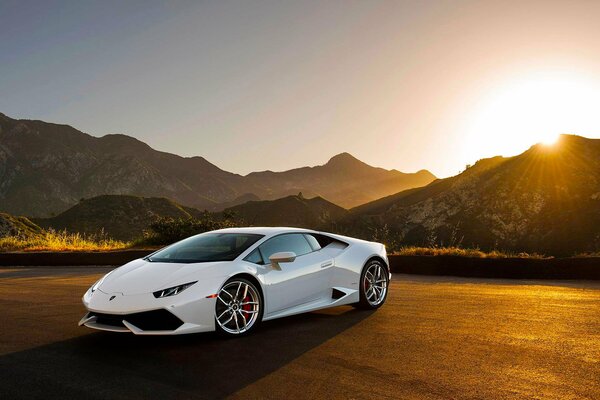 White Lamborghini Urakan on the background of sunset among the mountains