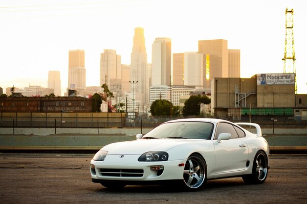 White Toyota car on the background of a railway station