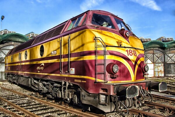 Railway art with an unusually painted locomotive at the station