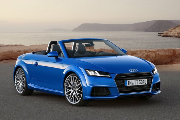 Blue audi tt on the background of the seashore