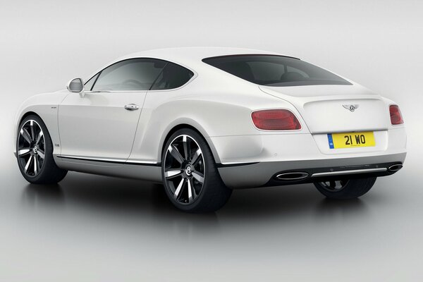 A white Bentley is standing in the studio for a photo