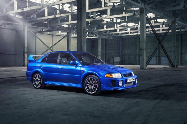 Blue Mitsubishi Lancer Evolution V in the garage