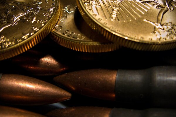 Bullets for the machine gun lie under a pile of coins