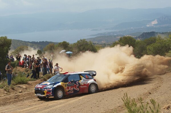 Racing citroen on rally drifts, disperses dust