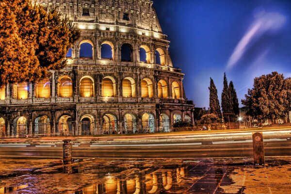 The evening Colosseum looks grand against the blue sky