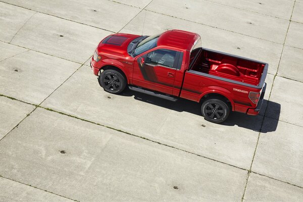 Red Ford car on the platform