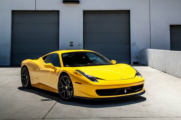 Yellow Ferrari on the background of garages