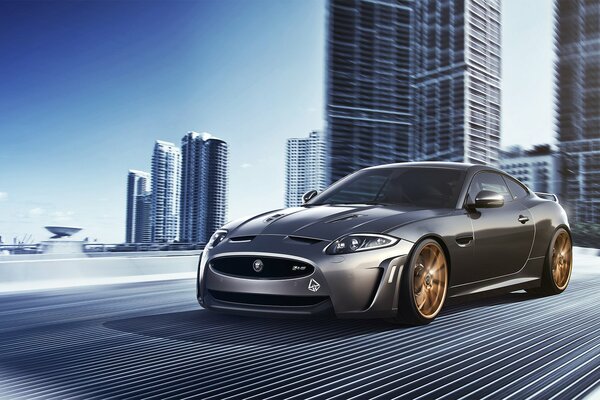 The concept of a silver jaguar xkr-s on the background of the city