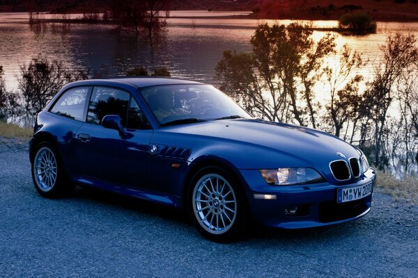 Bmw on the background of the evening lake