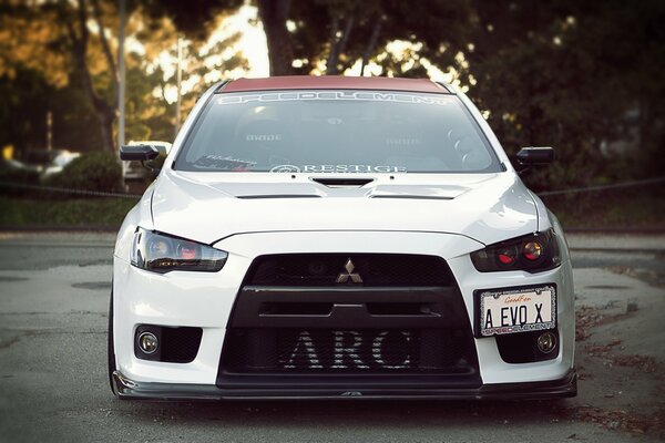 White Mitsubishi front view on the road