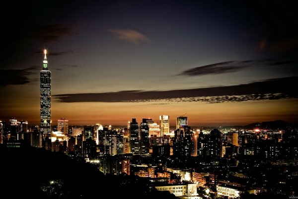 Night city lights among skyscrapers