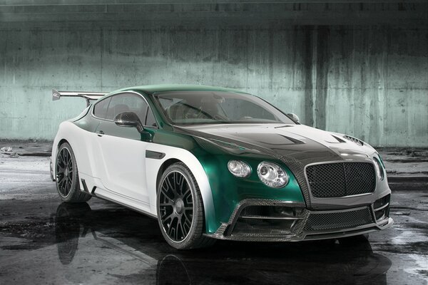 A white and emerald Bentley on a nondescript background