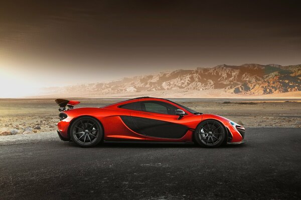 Exotic supercar on the background of desert mountains