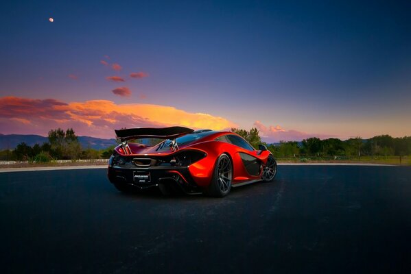 Hypercar orange on a beautiful sky background