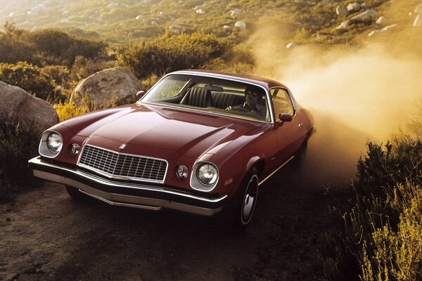 Red 1974 chevrolet on a rocky road