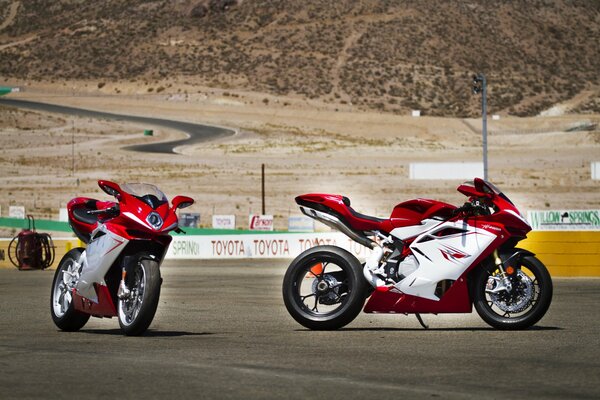 Red motorcycles are rushing along the highway