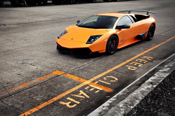 A Lamborghini sports car is driving on the highway