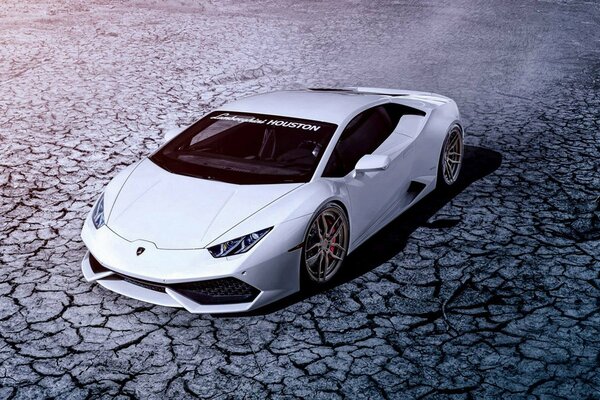 White lamborghini on a dry cracked road