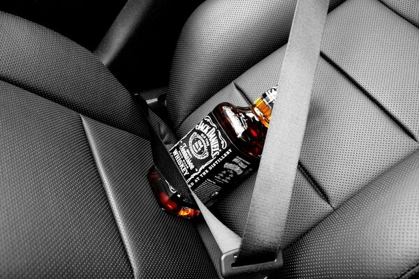 Jack Daniels bottle strapped on the seat