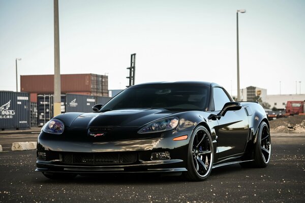 Black chevrolet zr1 on the background of an urban landscape