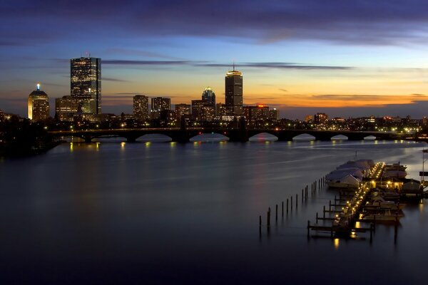 Sunset on the pier against the backdrop of a modern city