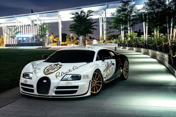 White and black Bugatti with gold discs