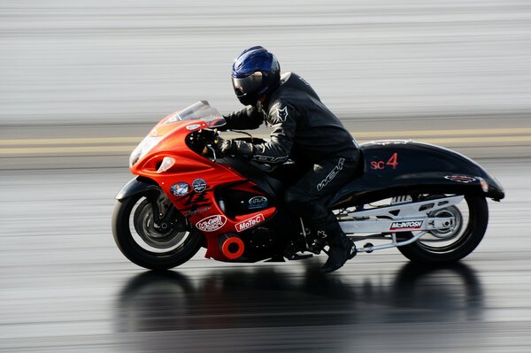 A motorcycle biker rides on a race track