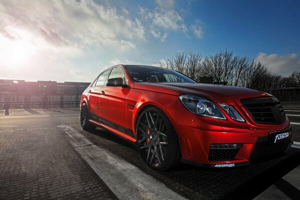 Red Mercedes-Benz AMG on the sky background