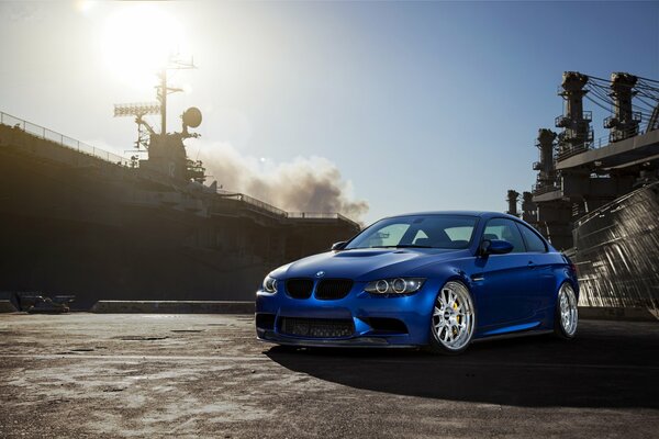 Blue BMW m3, against the background of sun and smoke