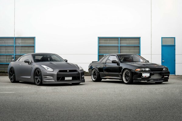 Two Nissan cars of the old and new generation