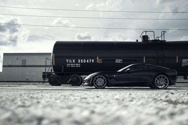 Black Chevrolet next to the tank