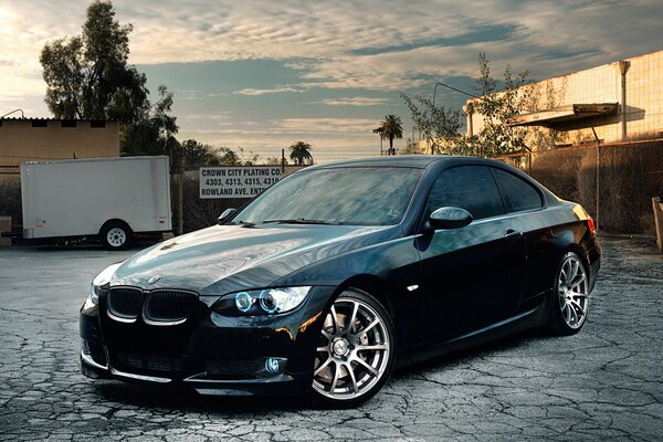 Black Bmw with headlights on