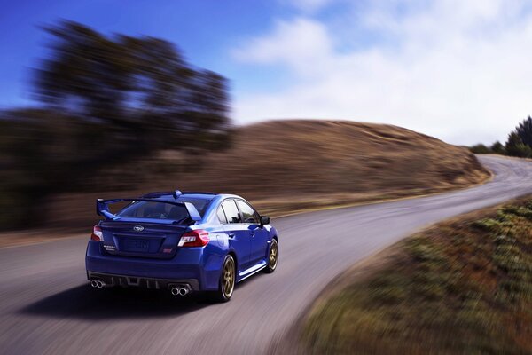 Blue Subaru in motion rear view