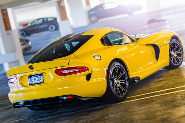 Yellow sports car in the underground parking