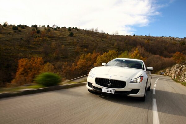 Maserati is rapidly moving through the autumn landscape