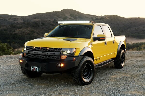 Ford velociraptor on the background of a mountain landscape
