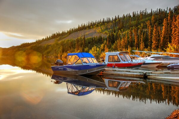 Motorboats on the pier of a calm lake