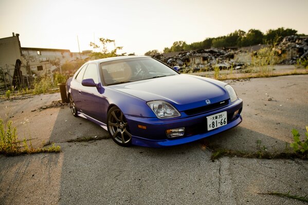 Blue Honda in the ruins of the city