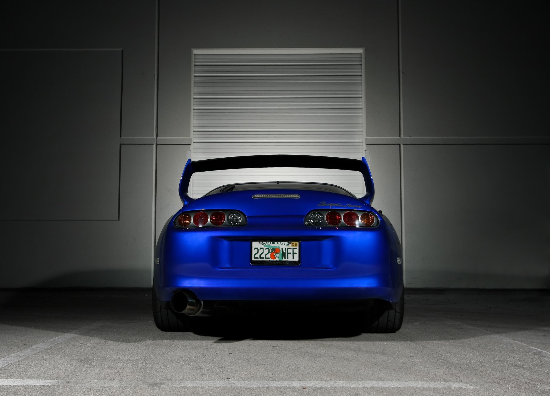 toyota above blue toyota supra blue rear wing exhaust pipe