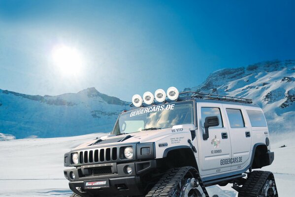Hummer SUV with tracks instead of wheels in the snow
