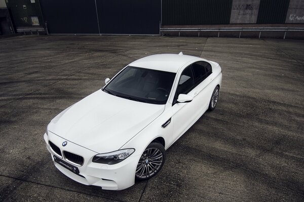 El coche blanco de la marca bmw se encuentra en el sitio