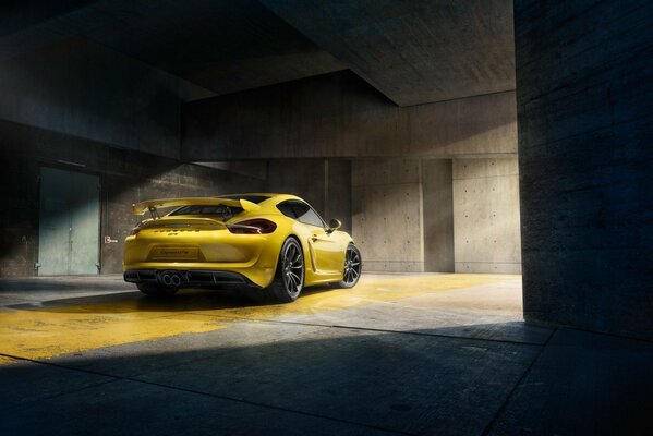 Yellow supercar porsche gt4 2015 in the sun