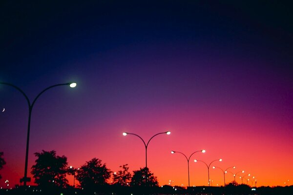 Lights on against the background of a red sunset