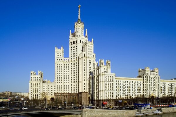 A large white building on the river bank