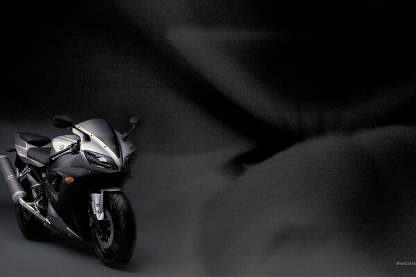 Stylish silver motorcycle on a dark background