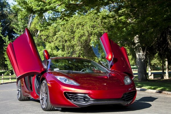 Red mclaren car with raised doors